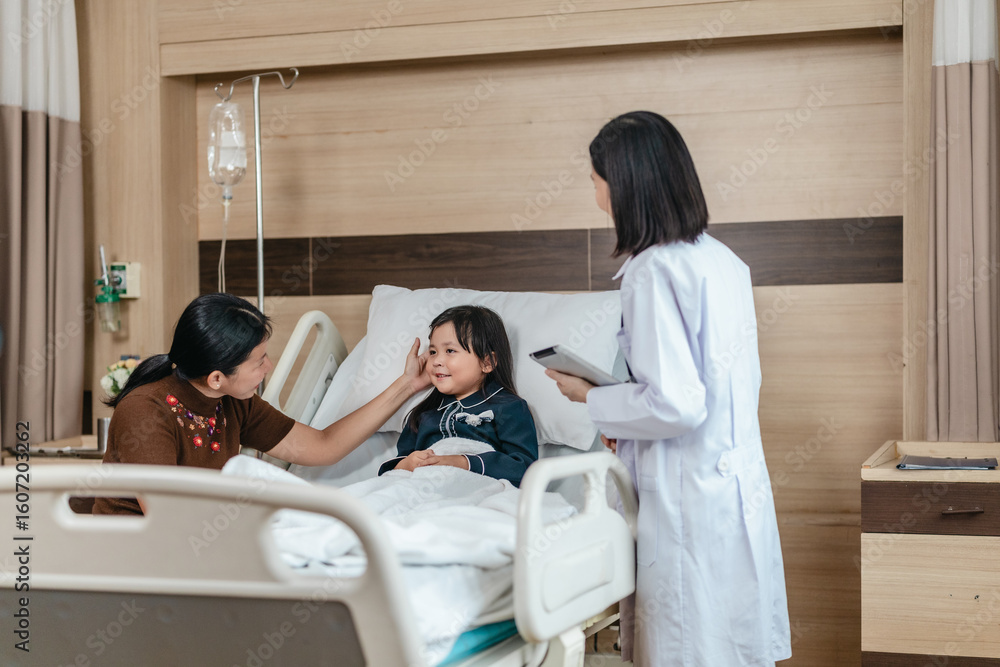Obraz premium Caring Asian Female Doctor with Child Patient and Mother