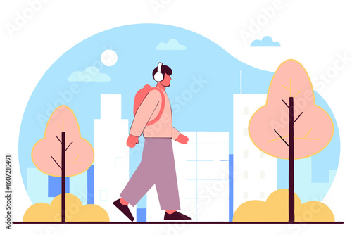 Mężczyzna w słuchawkach spacerujący po mieście. Koncepcja aktywnego, miejskiego stylu życia i relaksu.