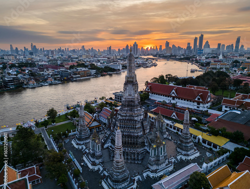 Photography Aerial top view of Temple of Dawn or Wat Arun statue and Chao Phraya River, Bangkok, Thailand in Rattanakosin Island in architecture, Urban old town city, skyline at sunrise