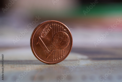 Close up of euro cent coin standing on edge, one cent value on front, fiat money