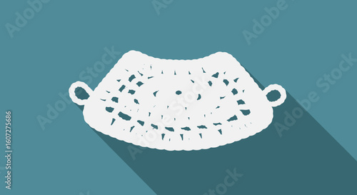 Delicate Crochet Doily Isolated on Teal Background with Long Shadow Creates an Antique Aesthetic with Artistic Textures