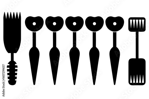 Collection of black cosmetic applicators and brushes on a white background