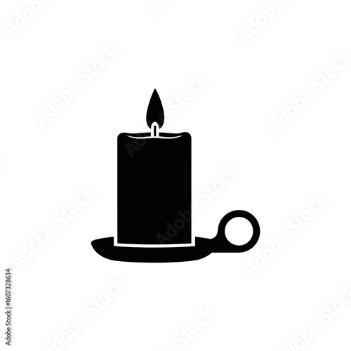 A lit candle in a holder is casting a soft glow in the darkness