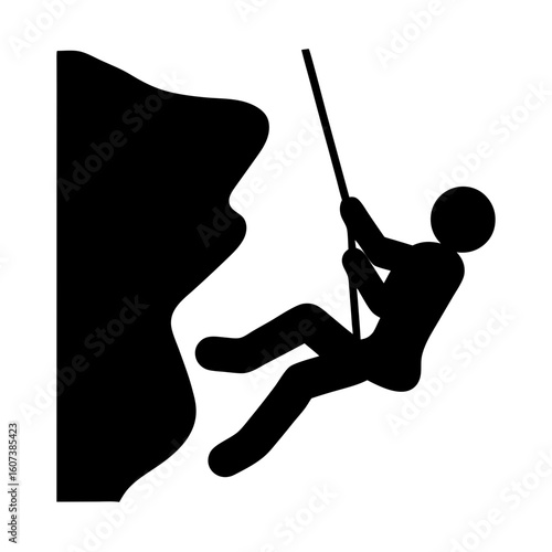 Silhouette of a rock climber rappelling down a cliff face with rope