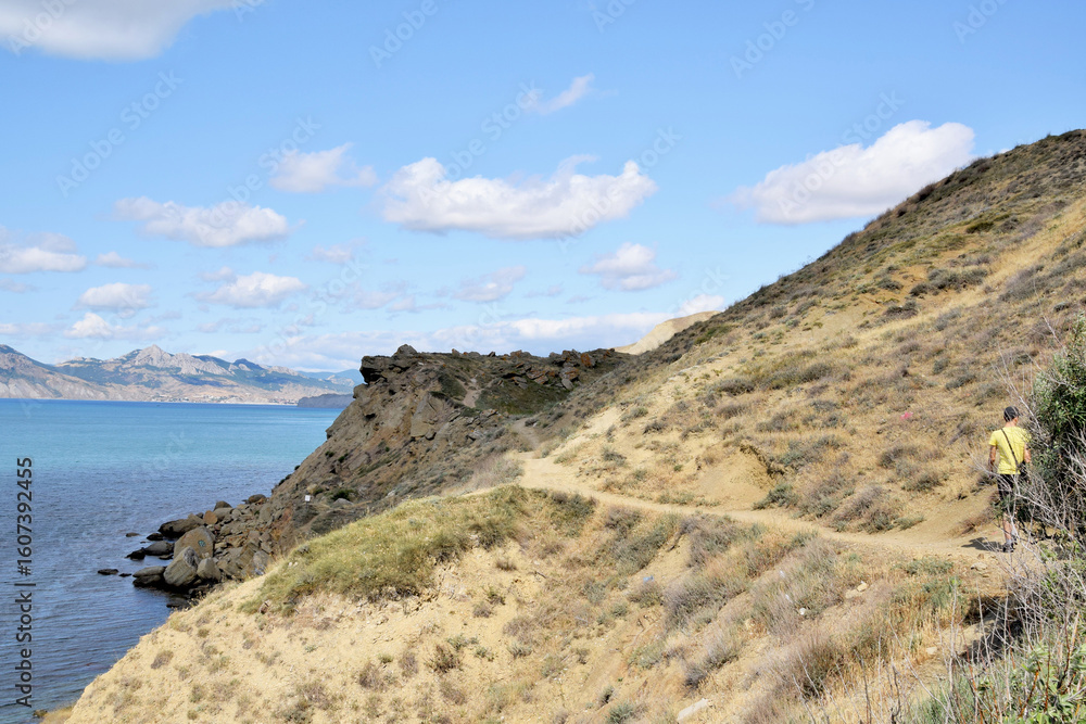 Travel and recreation. Road through the mountainous terrain along the sea coast Travel and recreation. Road through the mountainous terrain along the sea coast