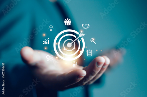 Businessman showing virtual target icon for business purpose, strategic planning for business growth and target customer group. Set business objectives goals, value, growth.	
