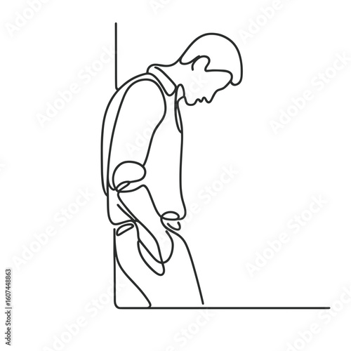 Man leaning head against wall