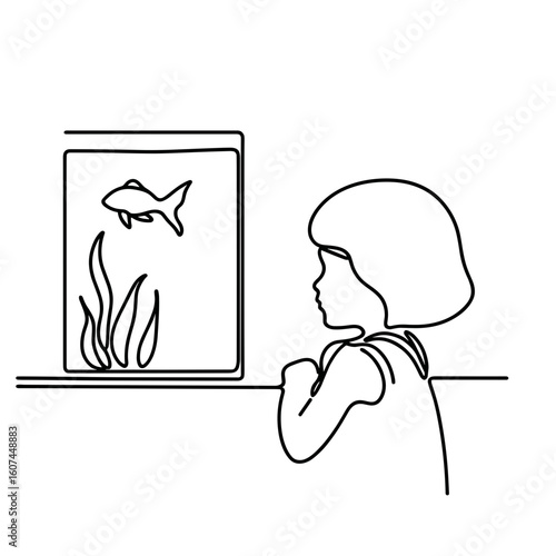 Child watching fish in aquarium