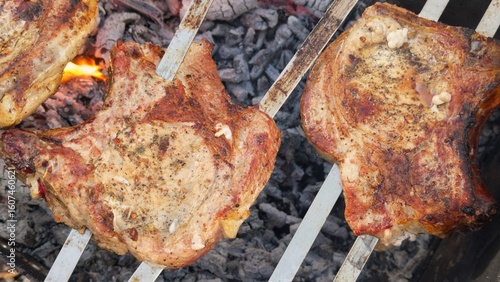 Juicy meat pieces grill over coals, releasing aromatic smoke, evoking a barbecue atmosphere