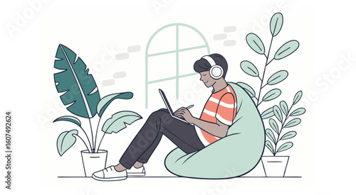 Person wearing headphones using a laptop on a beanbag chair surrounded by plants