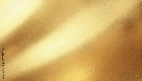 Close-up view of shiny gold metallic fabric, folded in half, with light beige background. Reflective properties of fabric create visual interest. Gold sheen and texture highlighted.