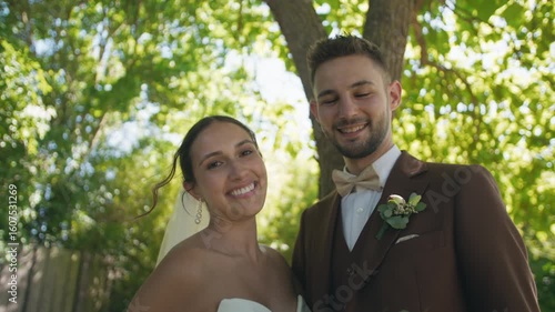 Wedding bride and groom smiling happy pulling having fun man and woman wedding day sun