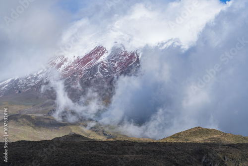 View of snow-capped Cotopaxi from the moors of the national park, showcasing the beauty of its lakes and hills. Ecuadorian biodiversity
