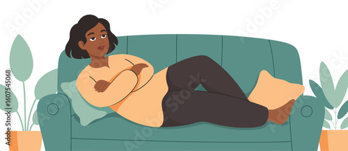 Woman lying on a couch looking upset with arms crossed