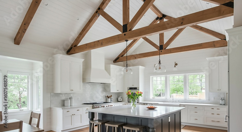 Elegant and spacious kitchen showcasing a vaulted ceiling with exposed wood beam trusses, white cabinets, and a large central island.