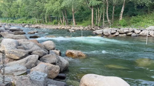 Rocky riverbank with fast flowing water

