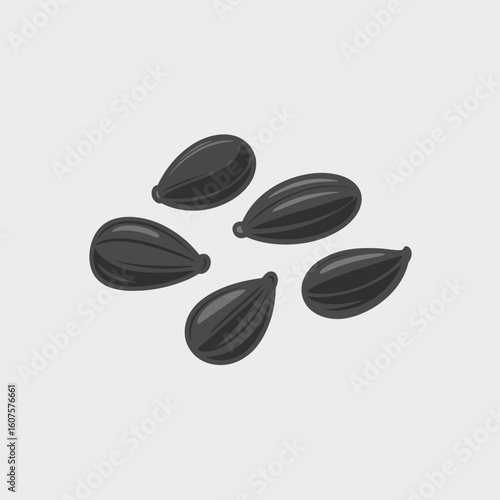 Close up of five black sunflower seeds scattered on a light gray background