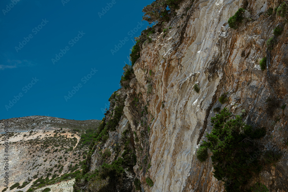 Obraz premium Low angle view of limestone cliff face showing dramatic vertical rock formations and textures