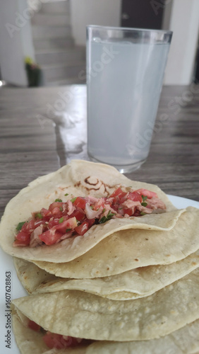 Healthy and tasty homemade food, diet: tuna tacos with pico de gallo and lemon water.