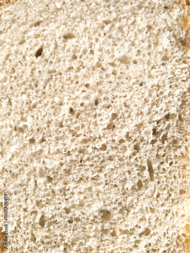 Close-up of white wheat bread slice texture.