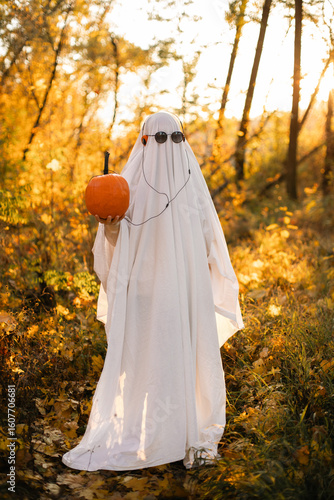 A ghost in orange headphones that are plugged into a pumpkin