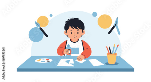Young Boy Creates Artwork At Table With Painting Tools And Paper Shapes