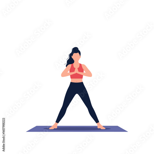 A woman in a red top and dark leggings stands on a yoga mat, hands pressed together in front of her chest, legs spread wide.