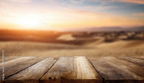 Wooden table top with a blurred desert sunset background