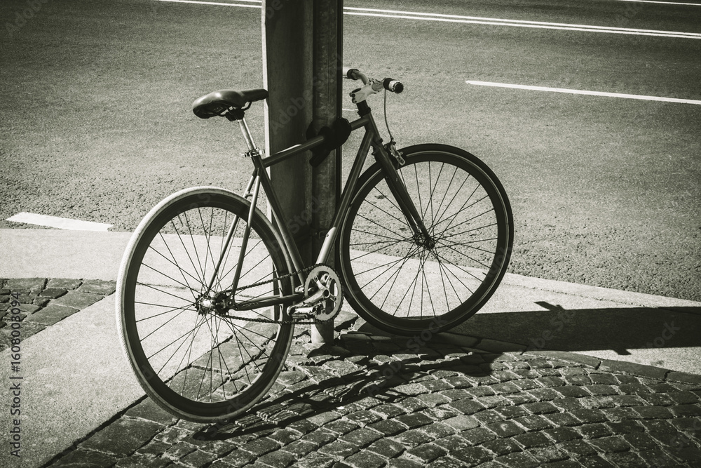 Obraz premium Black and white close up shot of an old bicycle. Old rusty vintage bicycle near the road. 