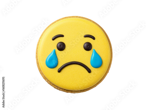 A single yellow emoji cookie with a sad face and blue teardrops isolated on transparent background