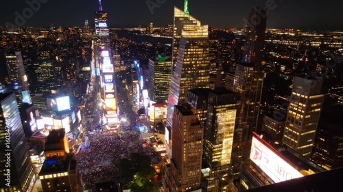 Aerial Nighttime View of Times Square Illuminated with Skyscrapers and Crowd in New York City