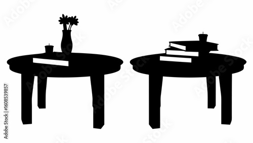 Two round tables in silhouette, one with a flower vase and a book, the other with stacked books and candle | editable eps vectors