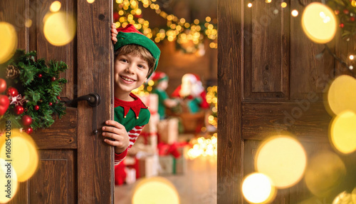 Joyful young boy dressed as an elf peeks out from behind wooden door, ready for Christmas, expressing excitement and anticipation