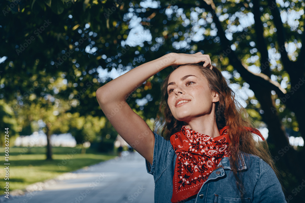 Naklejka premium lifestyle woman in modern boho-western denim street style wearing red bandana outdoors with bright film color sunlight and natural background