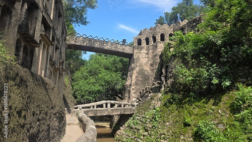 Stone bridges connect pathways across scenic garden streams