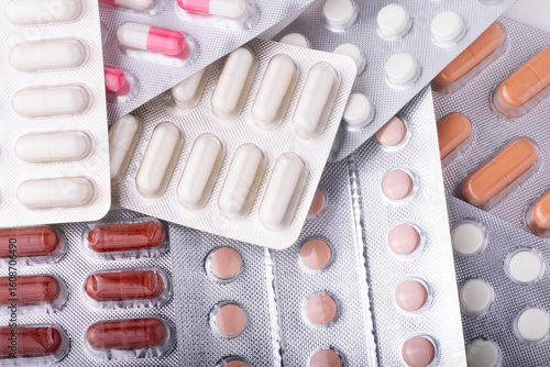 Multi-colored tablets and capsules in blister packaging, pharmaceutical industry concept