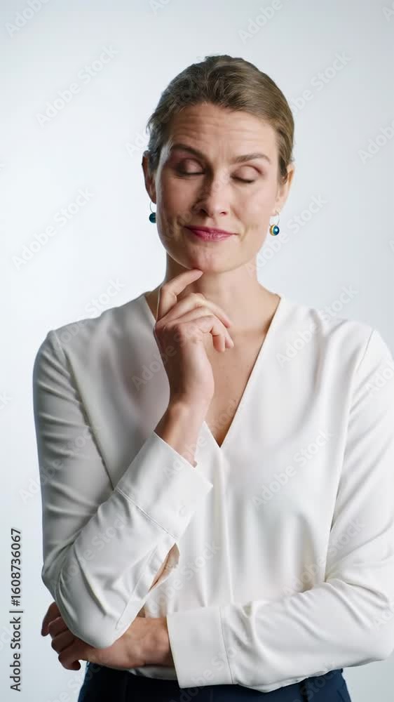 Professional in late 20s-early 30s in business casual, from contemplative gaze to confident smile, against transparent studio. Soft high-key light as video progresses with slow dolly zoom. Concept Professional in late 20s-early 30s in business casual, from contemplative gaze to confident smile, against transparent studio. Soft high-key light as video progresses with slow dolly zoom. Concept