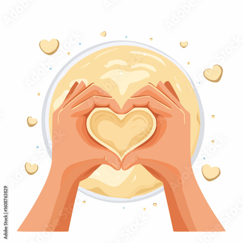 Hands forming a heart shape on dough in a bowl on white background