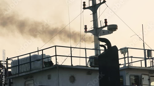 Black smoke from ferry boat flue, close up. Chimney of a ferry or ship, smokestack pollutes the atmosphere. Air pollution concept. Smoke from the exhaust pipe on the ship. slow motion video.