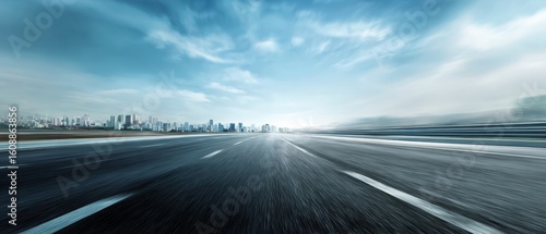 The expansive road leading towards a vibrant urban skyline under a dramatic sky.