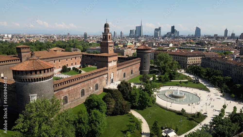 Obraz premium Europe, Italy, Milan 07,26,2025 Drone view of Sforza Castle tourist attraction in downtown with fountain, Sempione park and the new skyline with skyscrapers of Gae Aulenti and Citylife district