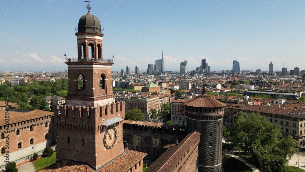 Obraz premium Europe, Italy, Milan 07,26,2025 Drone view of Sforza Castle tourist attraction in downtown with fountain, Sempione park and the new skyline with skyscrapers of Gae Aulenti and Citylife district