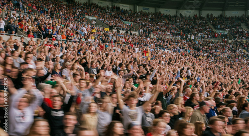 Enthusiastic crowd cheering in a stadium.