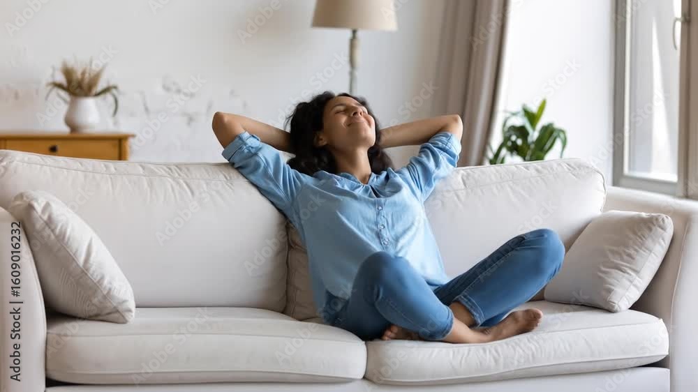 Relaxed Woman Enjoying Peaceful Moment on Sofa at Home in Casual Clothes Relaxed Woman Enjoying Peaceful Moment on Sofa at Home in Casual Clothes