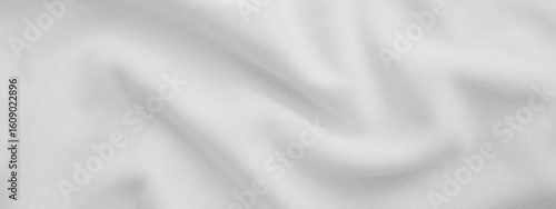 White wavy fabric background. Wrinkled cloth