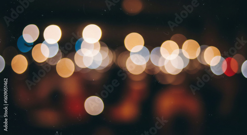 Abstract bokeh background with glittering city lights at night. Dreamy atmospheric urban light display concept.