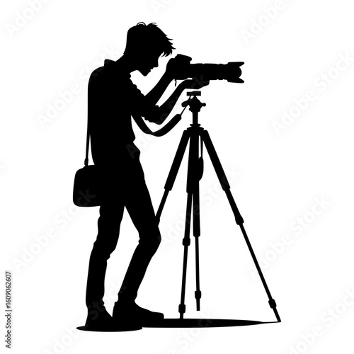 Silhouette of a photographer operating a camera on a tripod