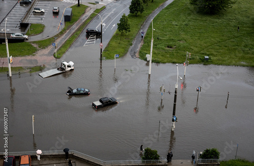 Aerial view of cars driving on flooded road