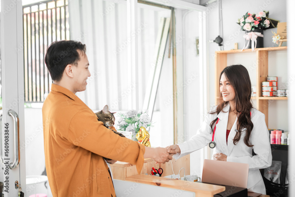 Asian female Veterinarian greet customers with a handshake Asian female Veterinarian greet customers with a handshake