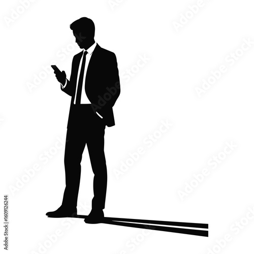 Silhouette of a businessman in a suit checking his smartphone with a long shadow